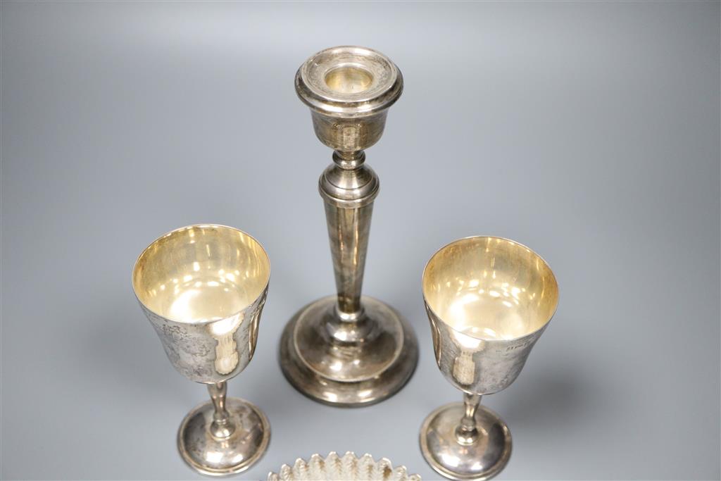 A pair of modern silver goblets, a silver candlestick, modern silver dis and pair of silver sugar tongs,